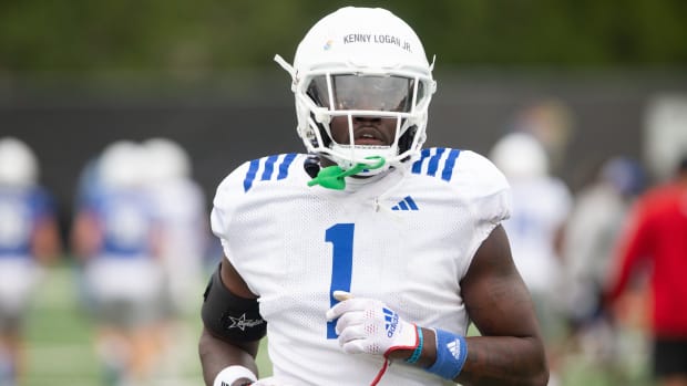 Kansas senior safety Kenny Logan Jr. (1) runs during Monday's outdoor practice.  
